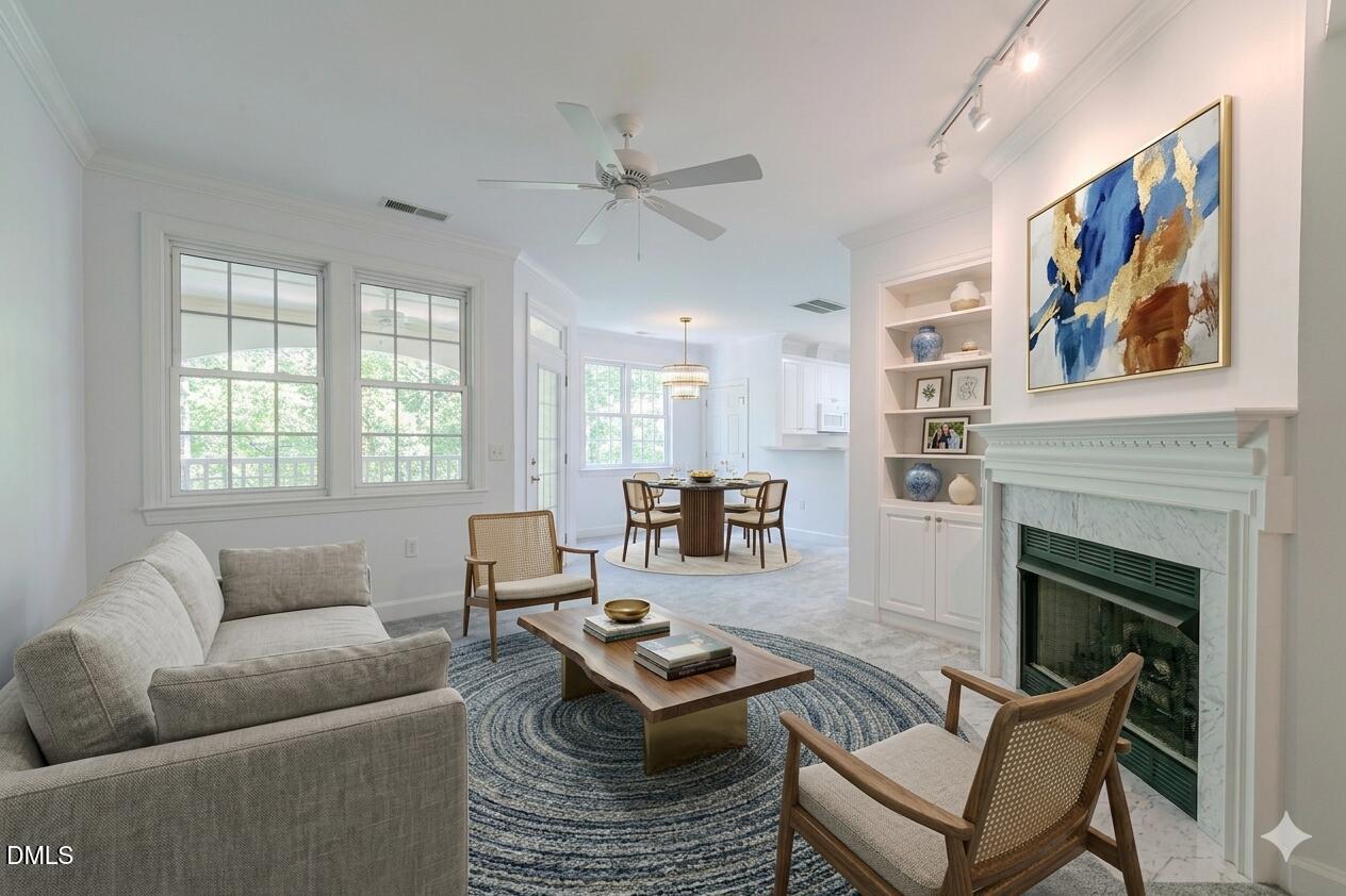 116 Northbrook Drive, Unit 305 Raleigh, NC 27609 - Photo 2 of 43 a living room with furniture and a fireplace