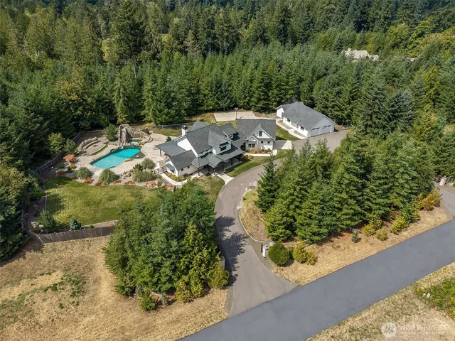 an aerial view of a house with yard swimming pool and outdoor seating