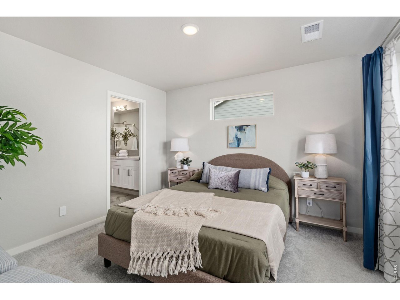 390 Cherokee Trail Ault, CO 80610 - Photo 15 of 37 a bedroom with a bed and a potted plant