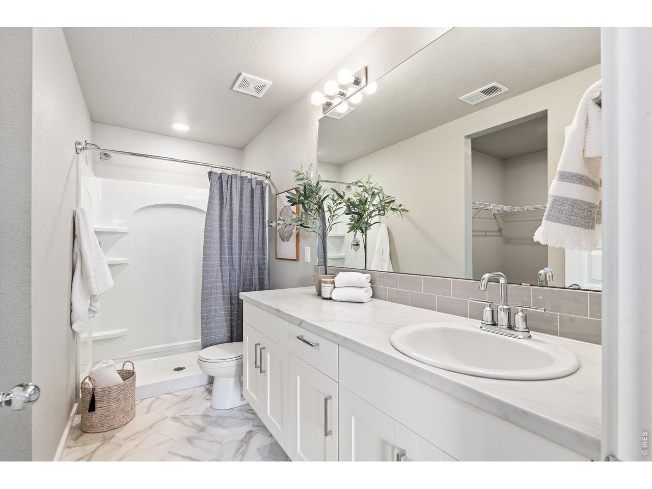 390 Cherokee Trail Ault, CO 80610 - Photo 22 of 37 a bathroom with a sink double vanity granite tub shower and a mirror