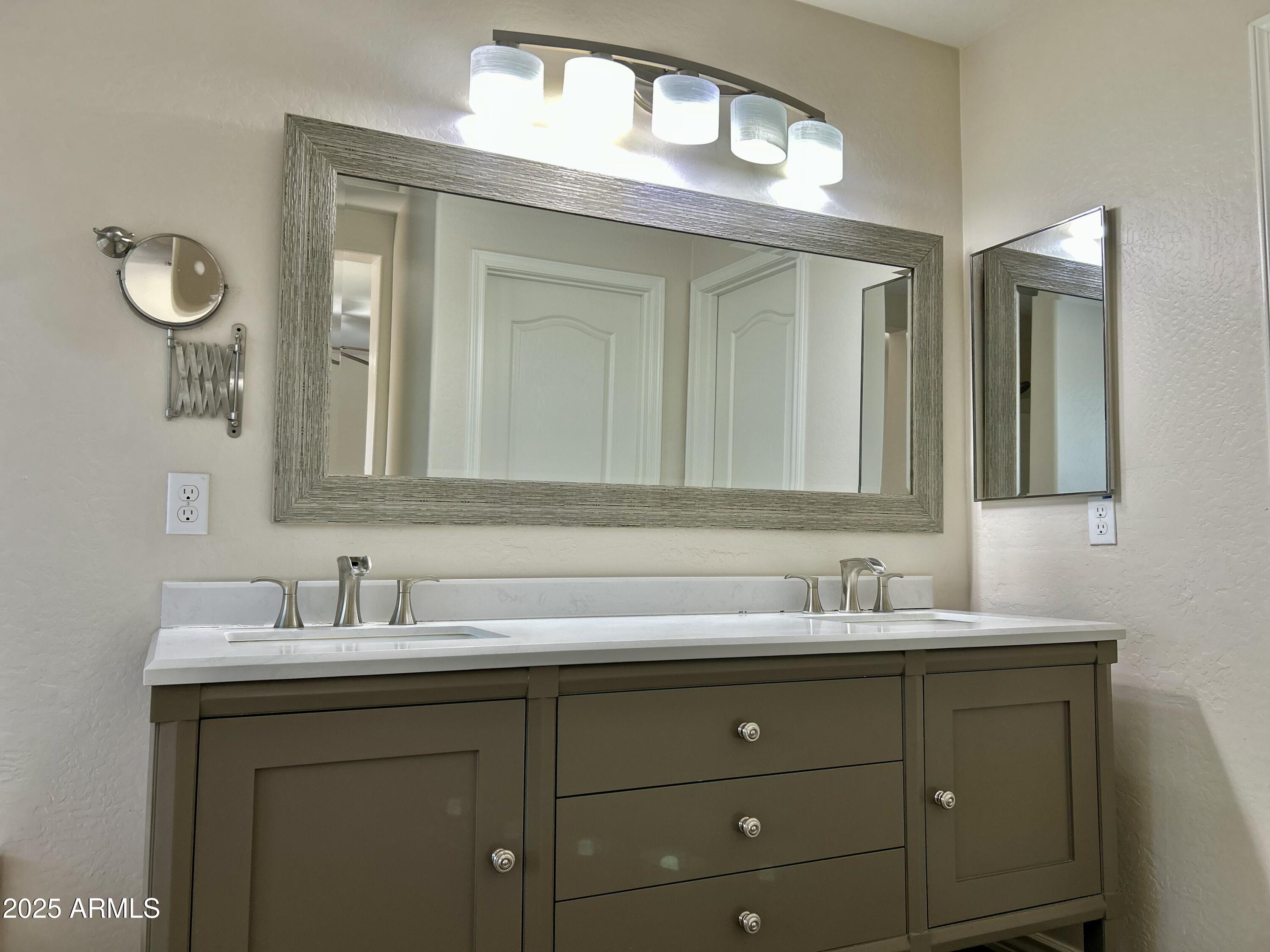 3853 East Santa Fe Lane Gilbert, AZ 85297 - Photo 14 of 23 a bathroom with a sink and two mirror