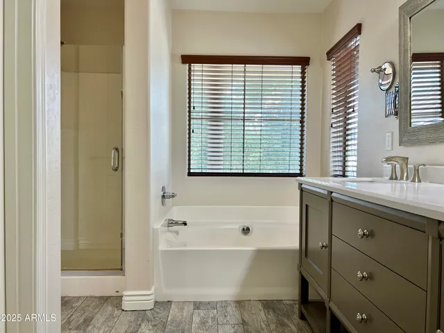 a bathroom with a bathtub sink and mirror