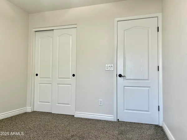 an empty room with closet area