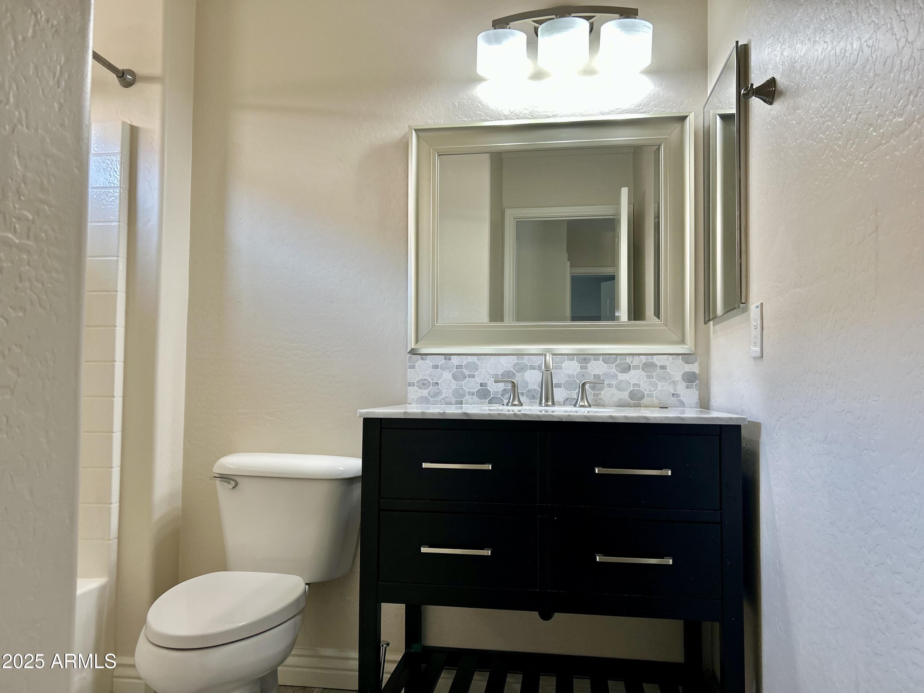 3853 East Santa Fe Lane Gilbert, AZ 85297 - Photo 20 of 23 a bathroom with a sink and a toilet