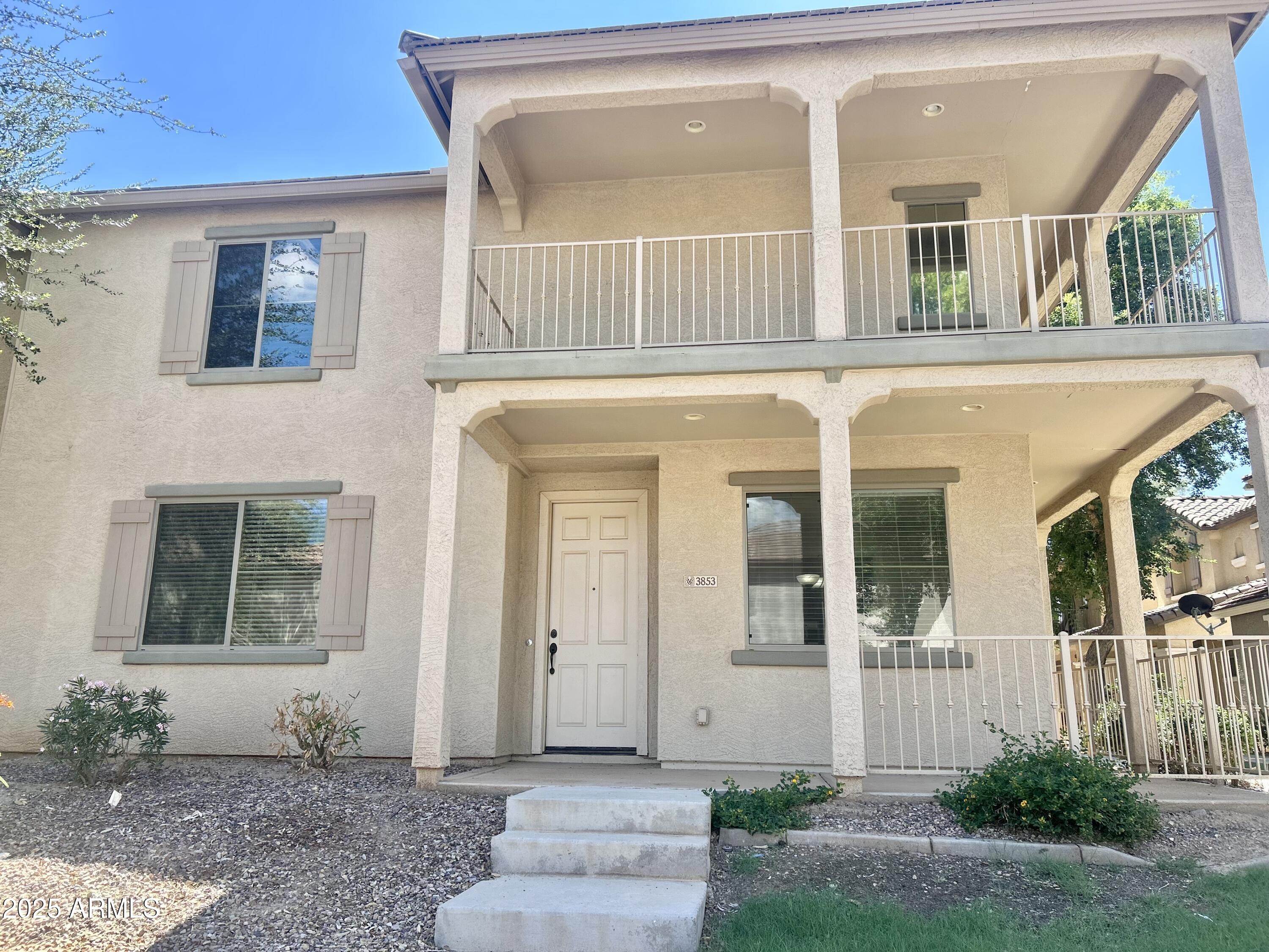3853 East Santa Fe Lane Gilbert, AZ 85297 - Photo 2 of 23 a front view of a house with a yard