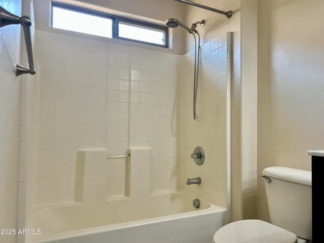 a bathroom with a toilet and shower