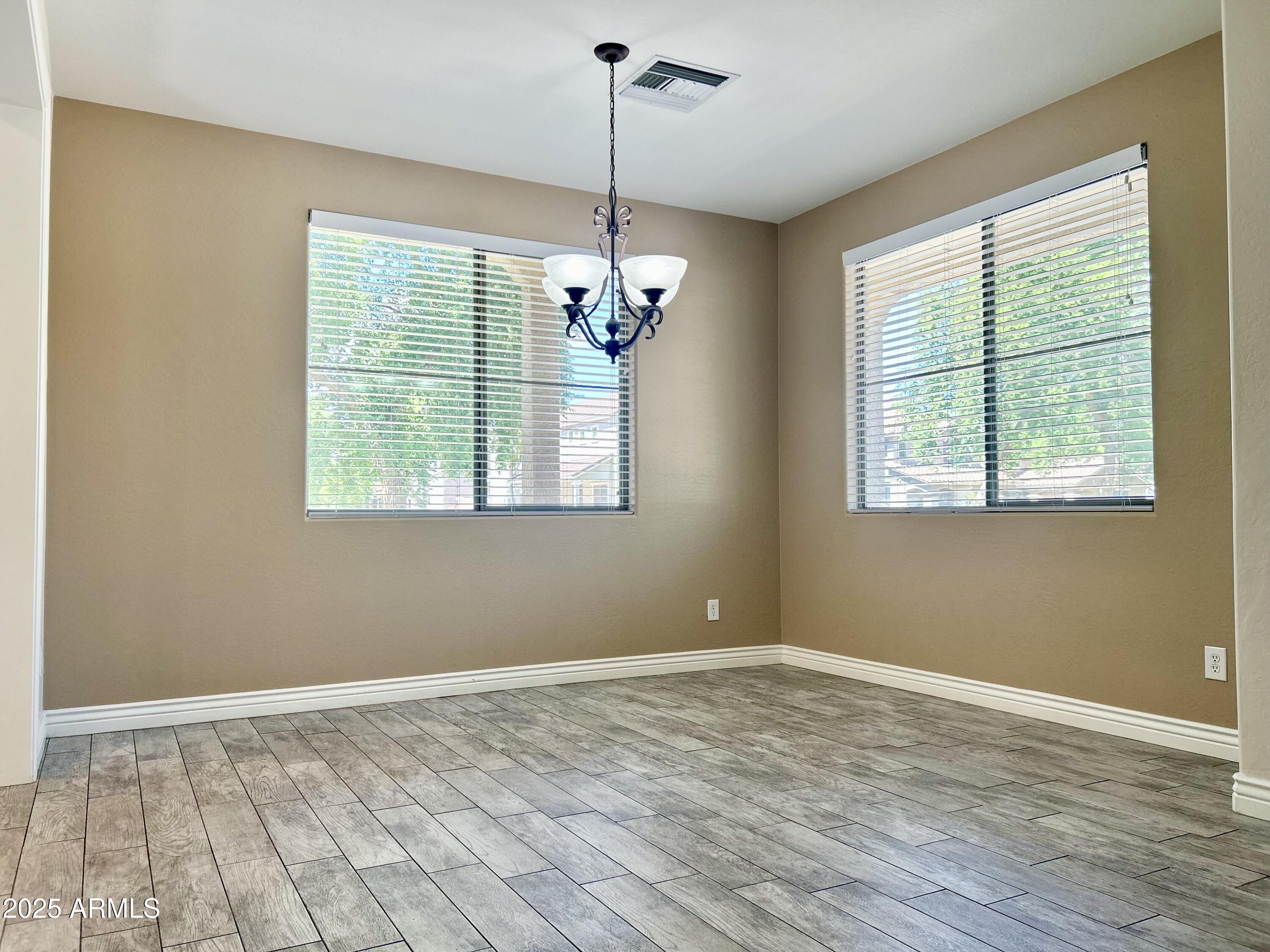 3853 East Santa Fe Lane Gilbert, AZ 85297 - Photo 5 of 23 a view of a room with windows and chandelier