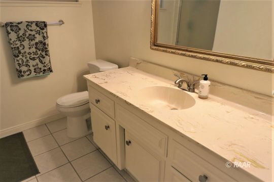 908 Randall Street Ridgecrest, CA 93555 - Photo 30 of 35 a bathroom with a sink and a toilet