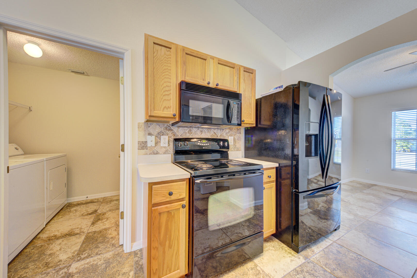 1453 Goyer Road Southeast Palm Bay, FL 32909 - Photo 13 of 41 kitchen & laundry room