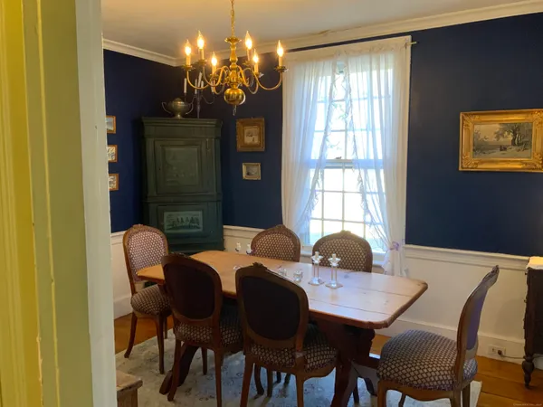 a view of a dining room with furniture and chandelier