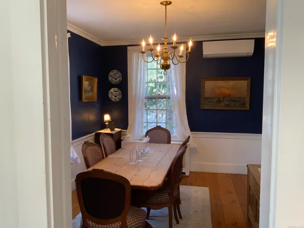 a dining room with furniture and chandelier