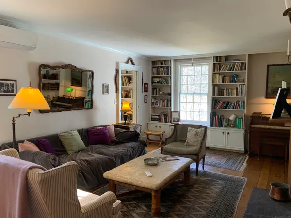 a living room with furniture and a flat screen tv with wooden floor