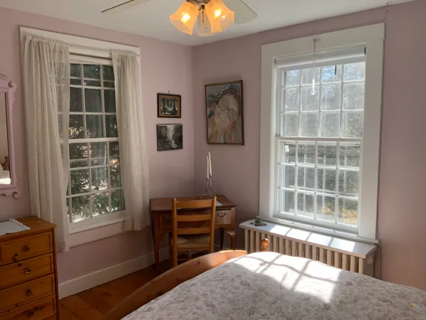 a bedroom with furniture and windows