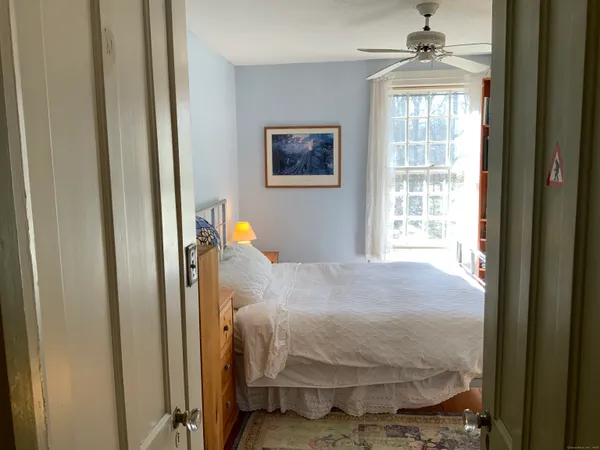 a bedroom with a bed and a window