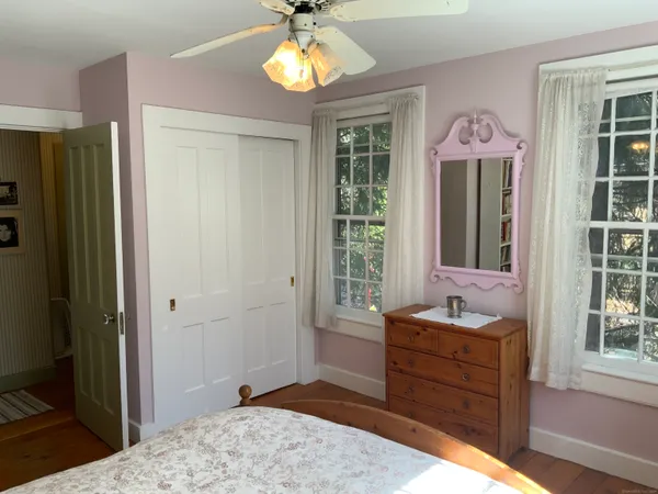 a bed room with a bed mirror and a window
