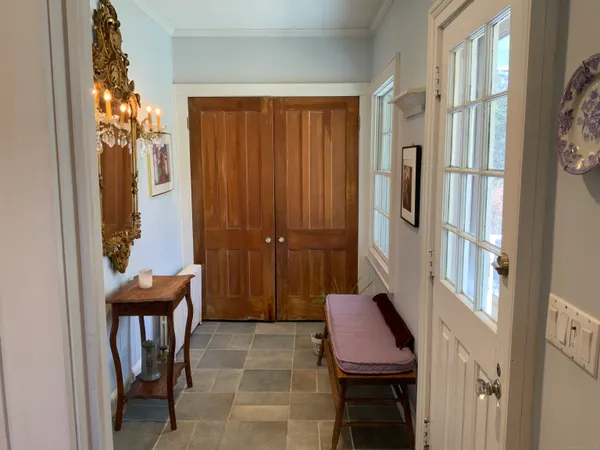 a view of a hallway with furniture and entryway