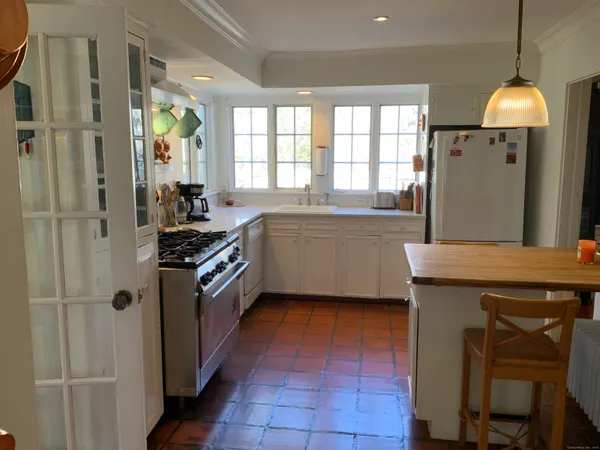 a kitchen with a stove a refrigerator and a sink
