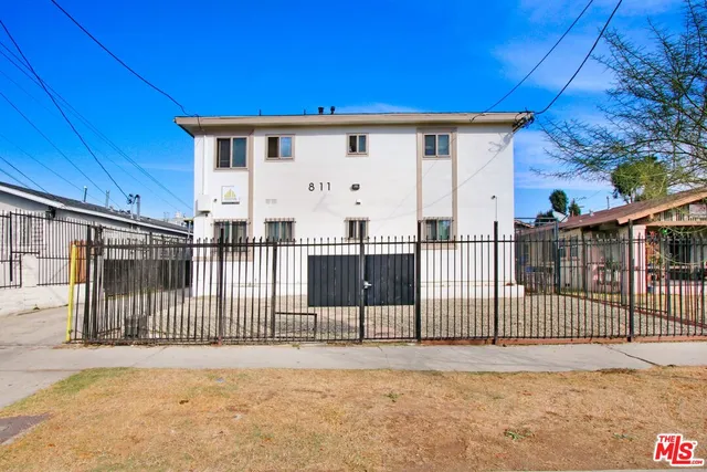 a view of a house with wooden fence