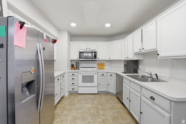 8083 North Ridge Loop East, Unit I 9 Eagle Mountain, UT 84005 - Photo 8 of 17 Kitchen featuring stainless steel appliances, light countertops, white cabinets, and recessed lighting