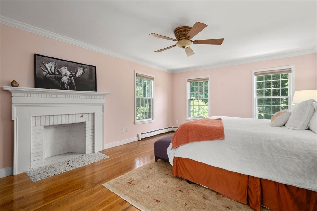 24 Russett Hill Road Sherborn, MA 01770 - Photo 17 of 39 a bedroom with a bed and a fireplace