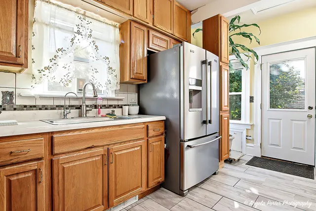 a kitchen with stainless steel appliances granite countertop a refrigerator and a sink