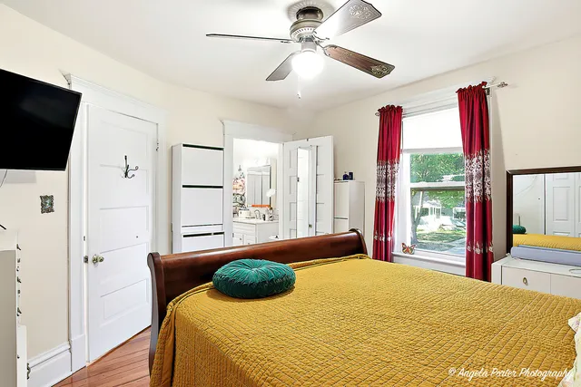 a bedroom with a bed and a flat screen tv