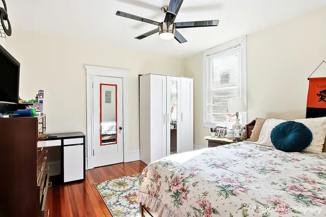 a bedroom with a bed and a dresser