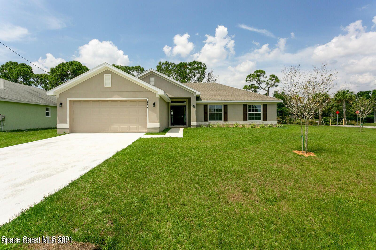 981 Degroodt Road Southwest, Unit 32 Palm Bay, FL 32908 - Photo 1 of 17 a front view of a house with garden