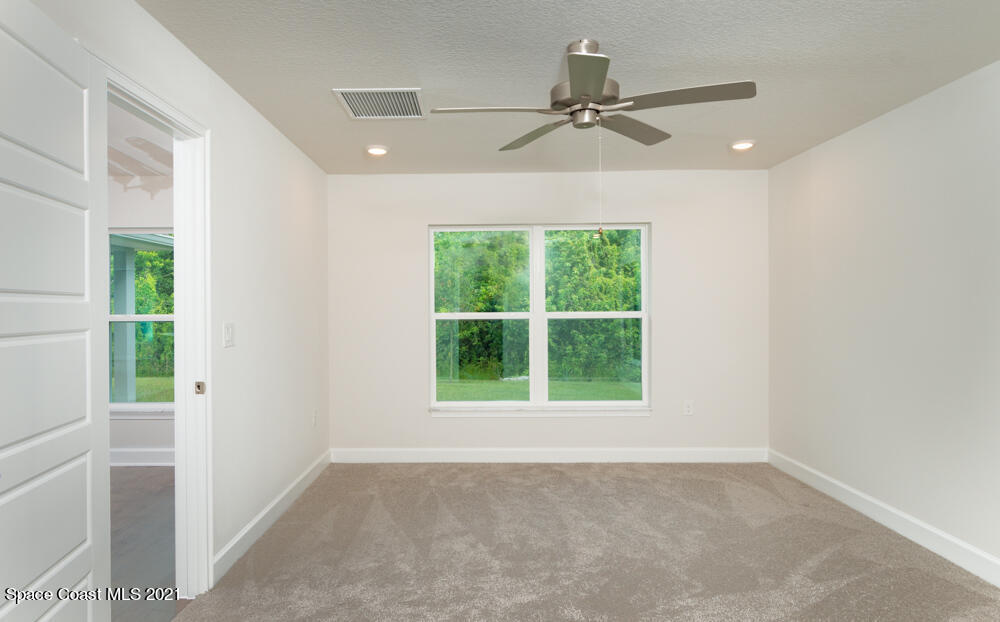 981 Degroodt Road Southwest, Unit 32 Palm Bay, FL 32908 - Photo 11 of 17 a view of an empty room with a window
