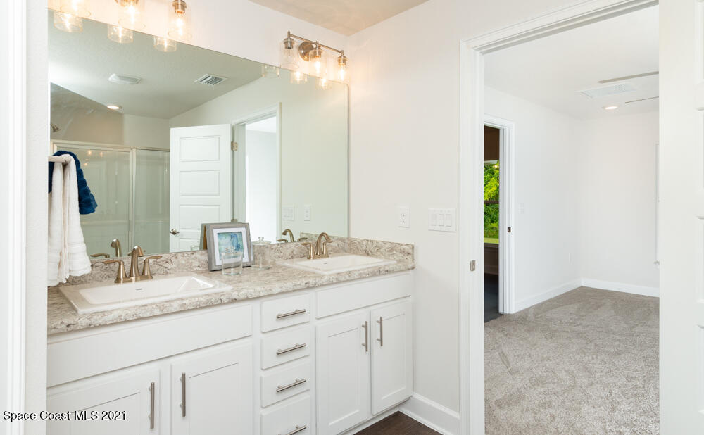981 Degroodt Road Southwest, Unit 32 Palm Bay, FL 32908 - Photo 13 of 17 a bathroom with a granite countertop sink and a mirror