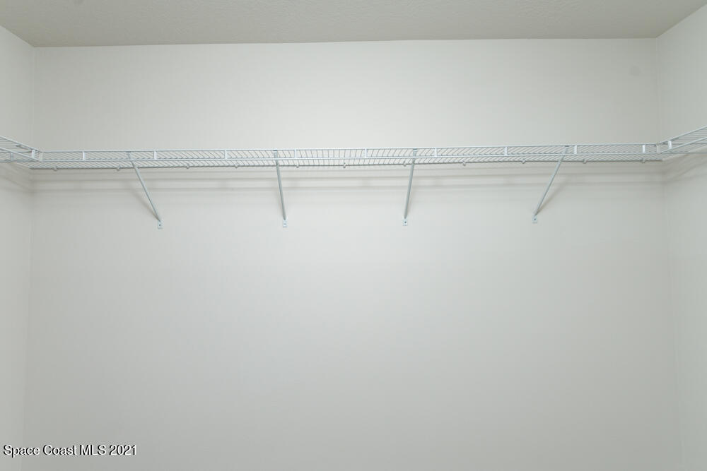 981 Degroodt Road Southwest, Unit 32 Palm Bay, FL 32908 - Photo 14 of 17 a view of a room with racks on the wall