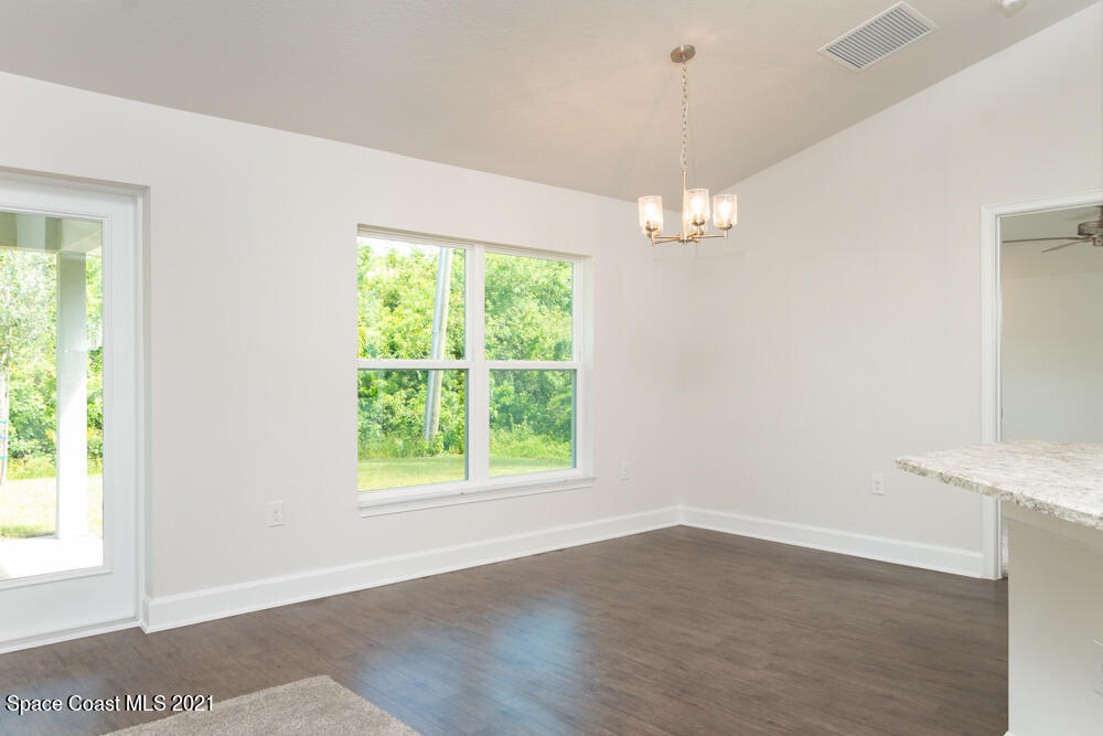 981 Degroodt Road Southwest, Unit 32 Palm Bay, FL 32908 - Photo 7 of 17 wooden floor in an empty room with a window
