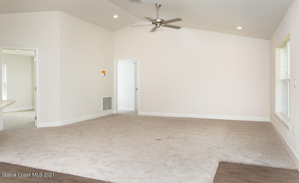 981 Degroodt Road Southwest, Unit 32 Palm Bay, FL 32908 - Photo 8 of 17 an empty room with a ceiling fan and a window
