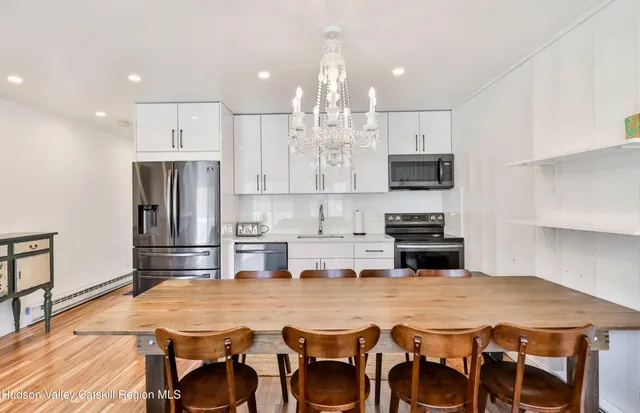 a living room with furniture and kitchen view