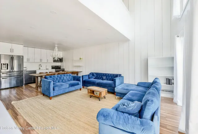 a kitchen with stainless steel appliances a table and chairs in it