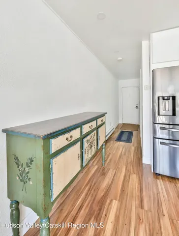 a living room with a balcony a bed furniture and a large window