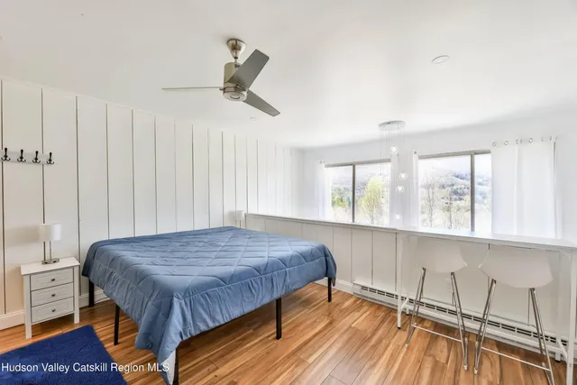 a bedroom with a bed and a dresser