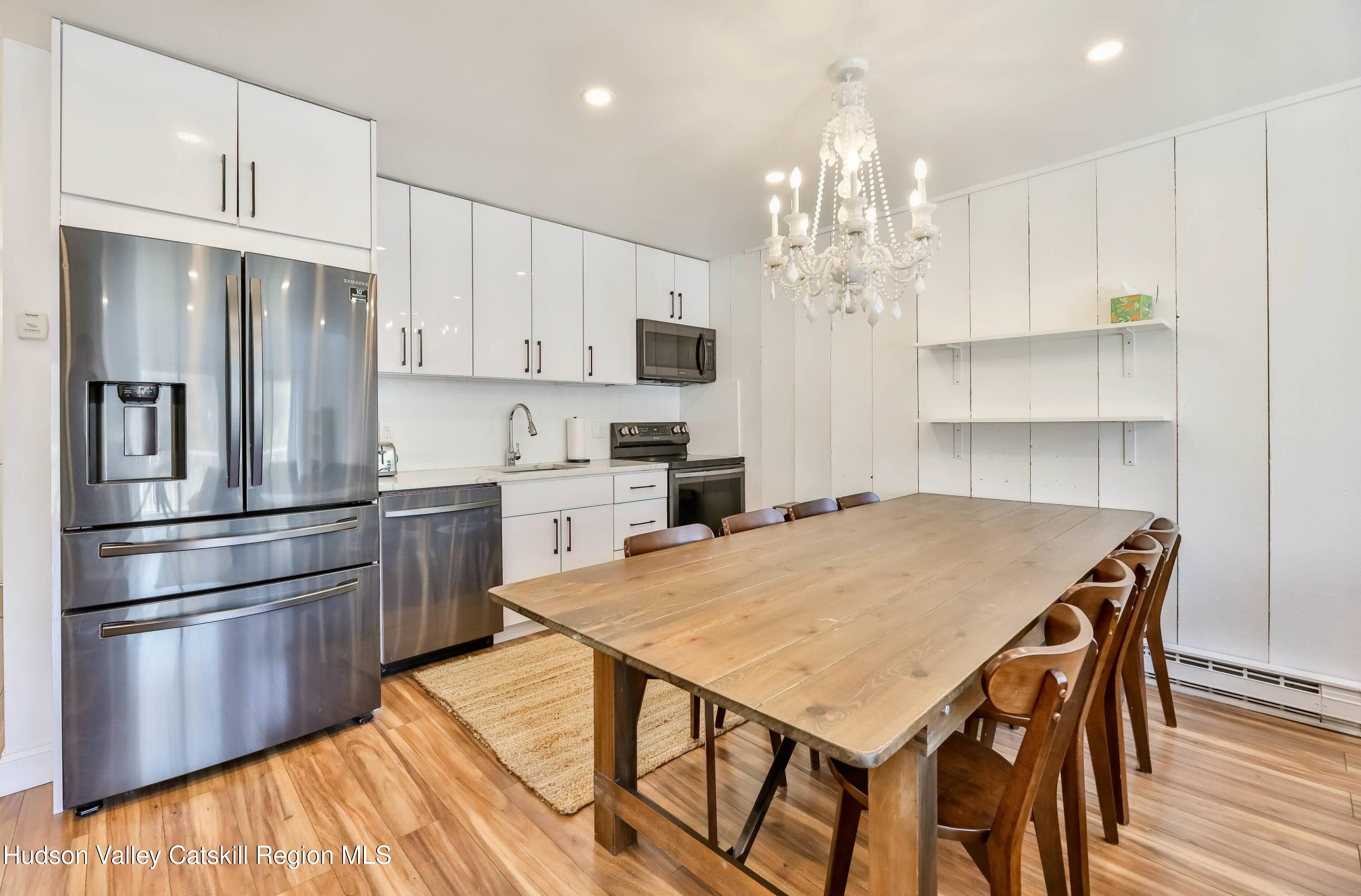 59 Scribner Hollow Road, Unit B2 Hunter, NY 12442 - Photo 2 of 42 a kitchen with kitchen island a refrigerator stove a sink and dishwasher