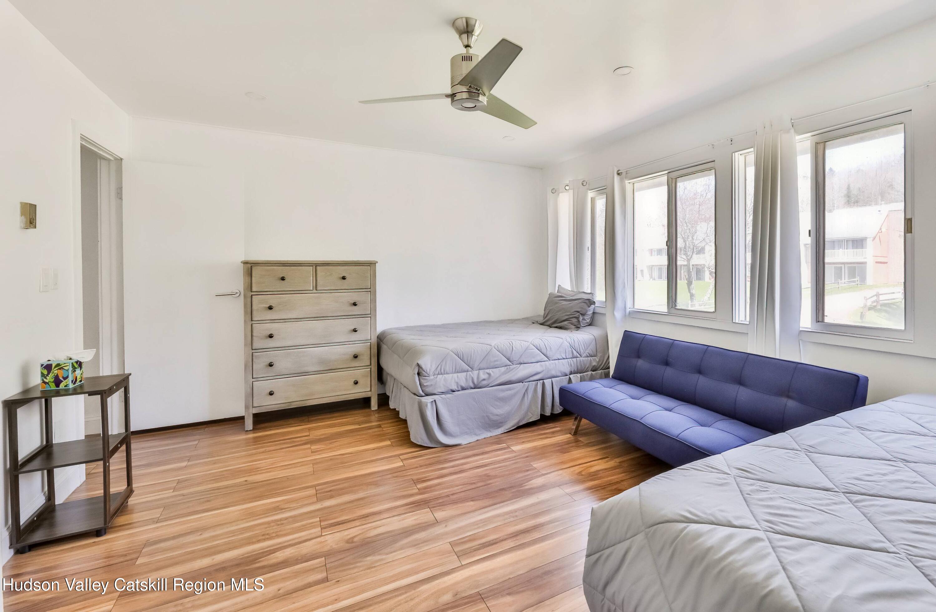 59 Scribner Hollow Road, Unit B2 Hunter, NY 12442 - Photo 23 of 42 a bedroom with a bed and a couch