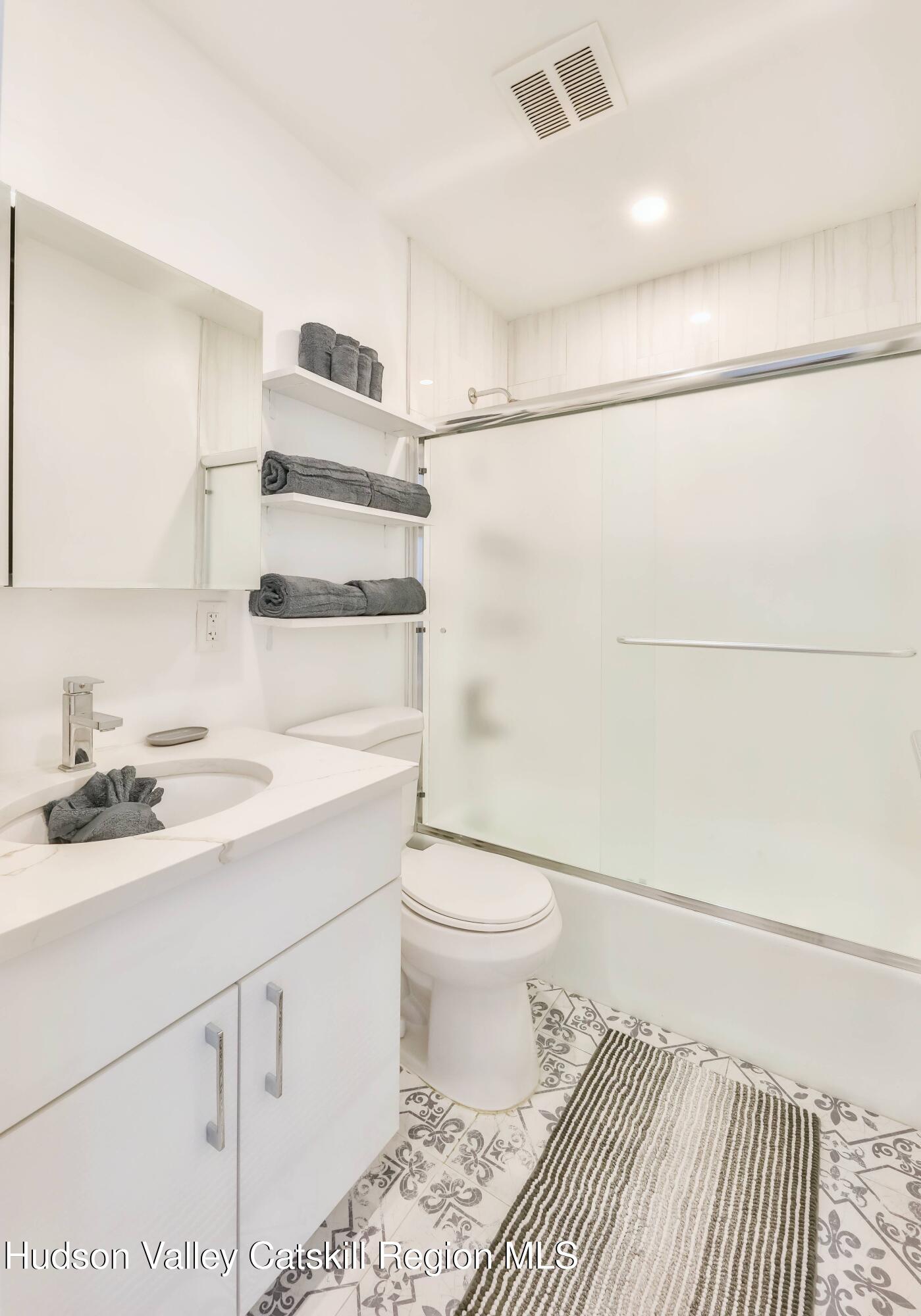 59 Scribner Hollow Road, Unit B2 Hunter, NY 12442 - Photo 25 of 42 a bathroom with a sink toilet and shower