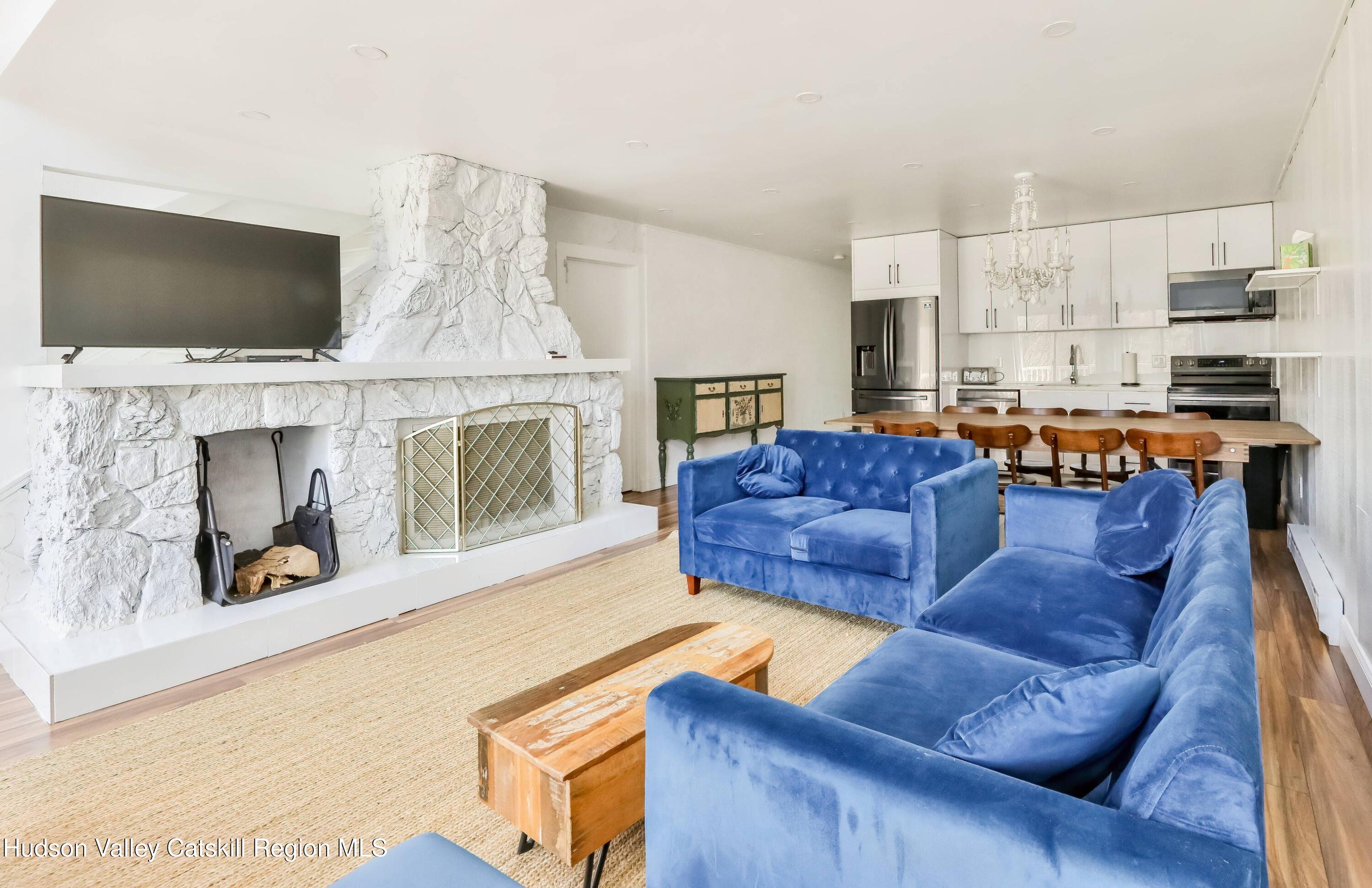 59 Scribner Hollow Road, Unit B2 Hunter, NY 12442 - Photo 3 of 42 a living room with furniture and a flat screen tv