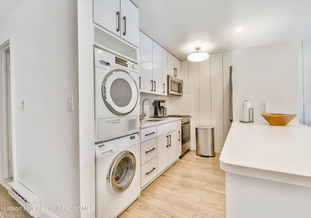 a kitchen with stainless steel appliances granite countertop a sink refrigerator and cabinets