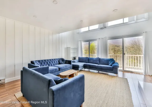 a large kitchen with kitchen island a white counter space a sink stainless steel appliances and cabinets
