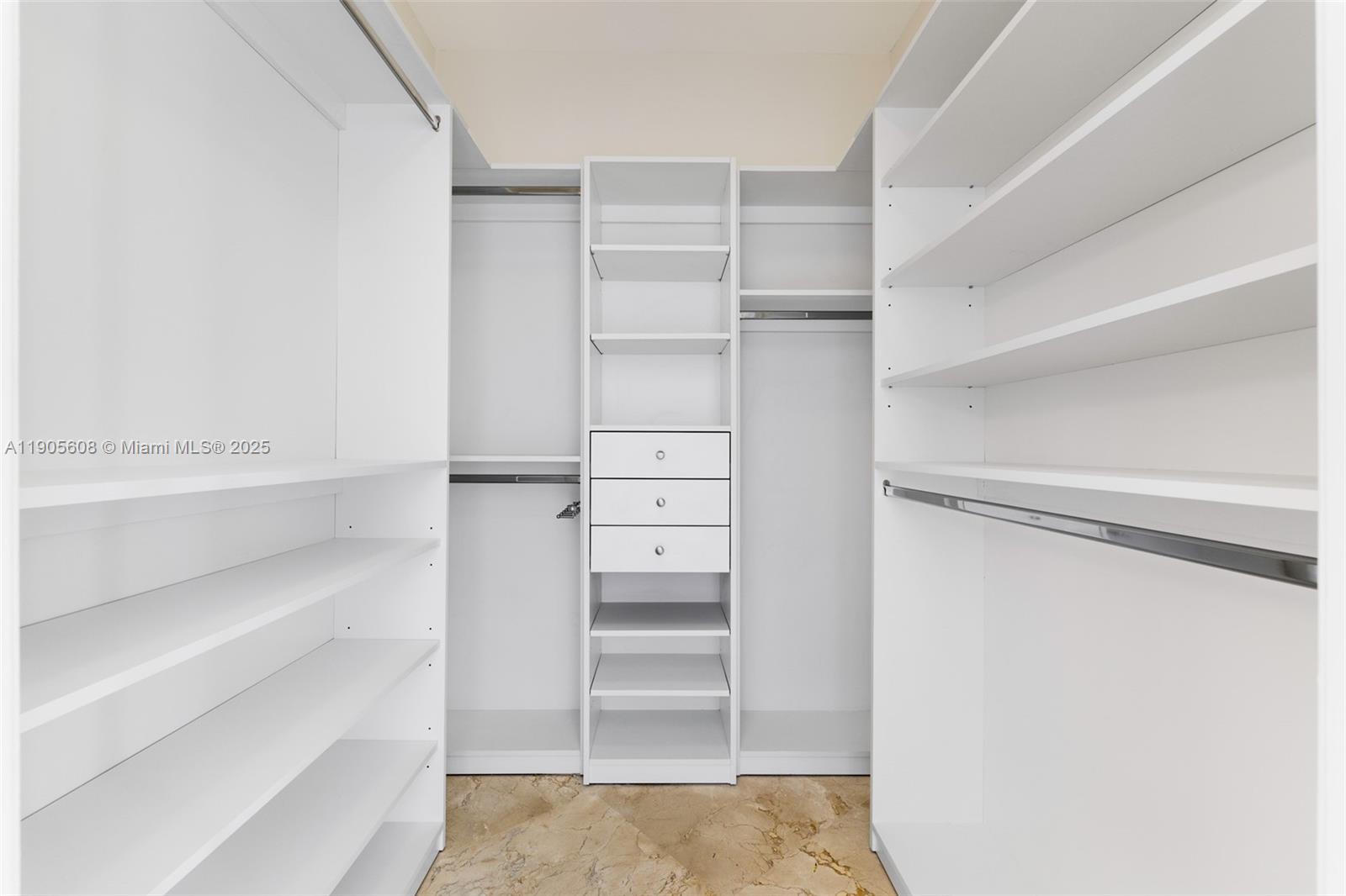 601 Northeast 36th Street, Unit 2304 Miami, FL 33137 - Photo 17 of 40 a view of walk in closet with empty racks
