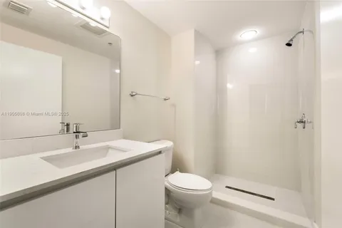 a bathroom with a sink toilet and a mirror