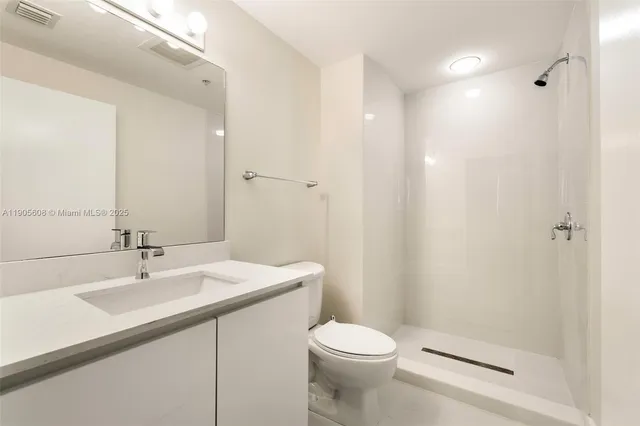 a bathroom with a sink toilet and a mirror