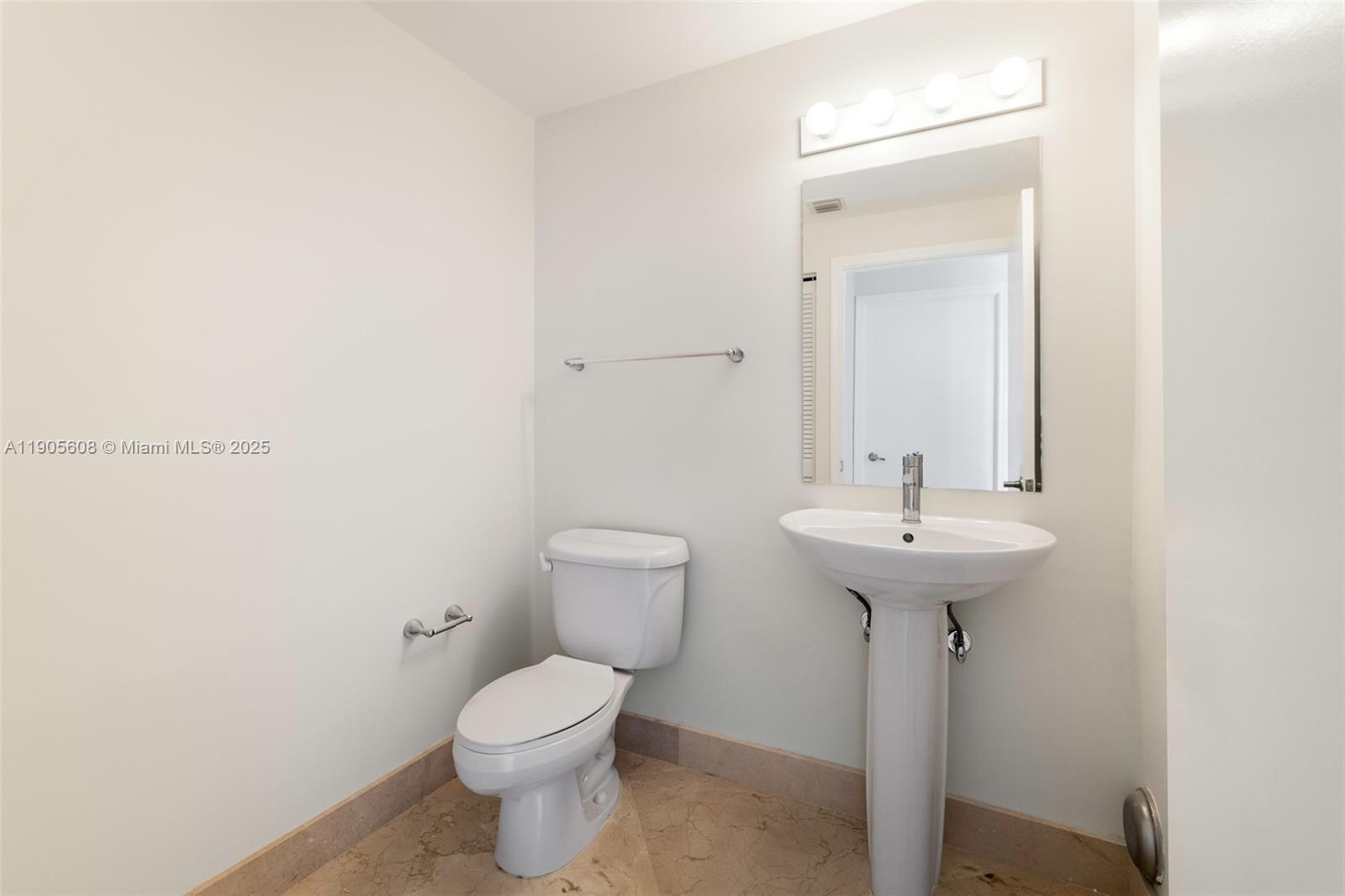 601 Northeast 36th Street, Unit 2304 Miami, FL 33137 - Photo 23 of 40 a bathroom with a sink toilet and a mirror