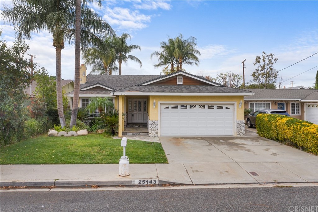 25143 Fourl Road Newhall, CA 91321 - Photo 1 of 1 a front view of a house with a garden and palm trees