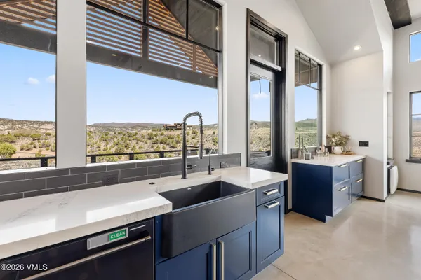 a white kitchen with a table and chairs in it