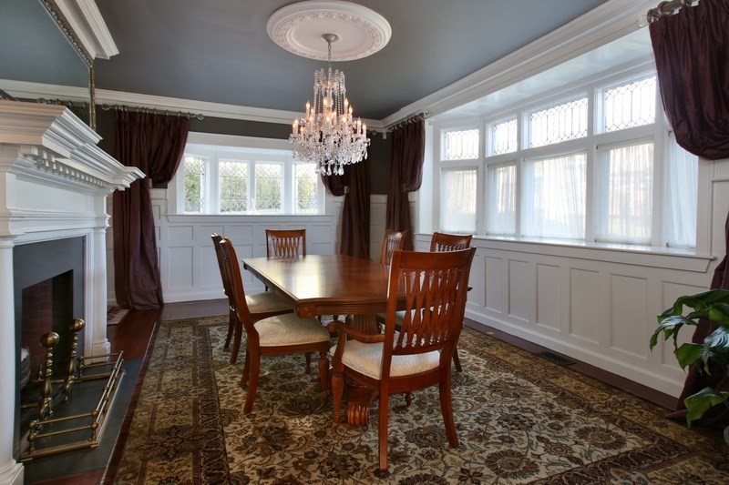 460 Heath Street Brookline, MA 02467 - Photo 12 of 22 a view of a dining room with furniture a chandelier and large windows